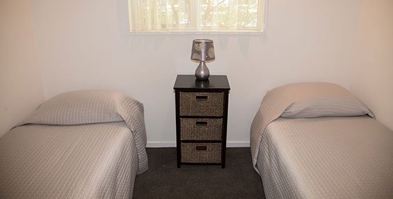 two single beds in the room of 1-bedroom unit